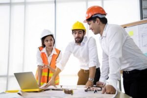 three architects in the office and discussing desi 7UUCQT2